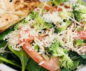 Salad with parmesan cheese, tomatoes, broccoli and pita
