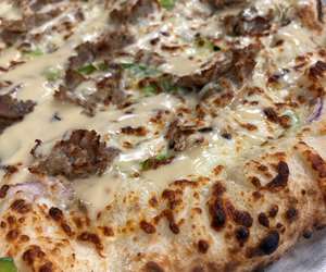 Specialty cheesesteak pizza