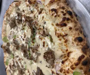 Specialty cheesesteak pizza